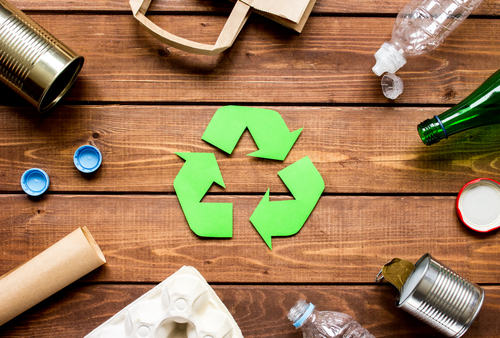 A recycling concept with various items and a central symbol